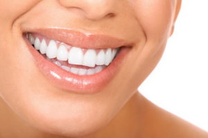 Smiling woman mouth with great teeth. Over white background